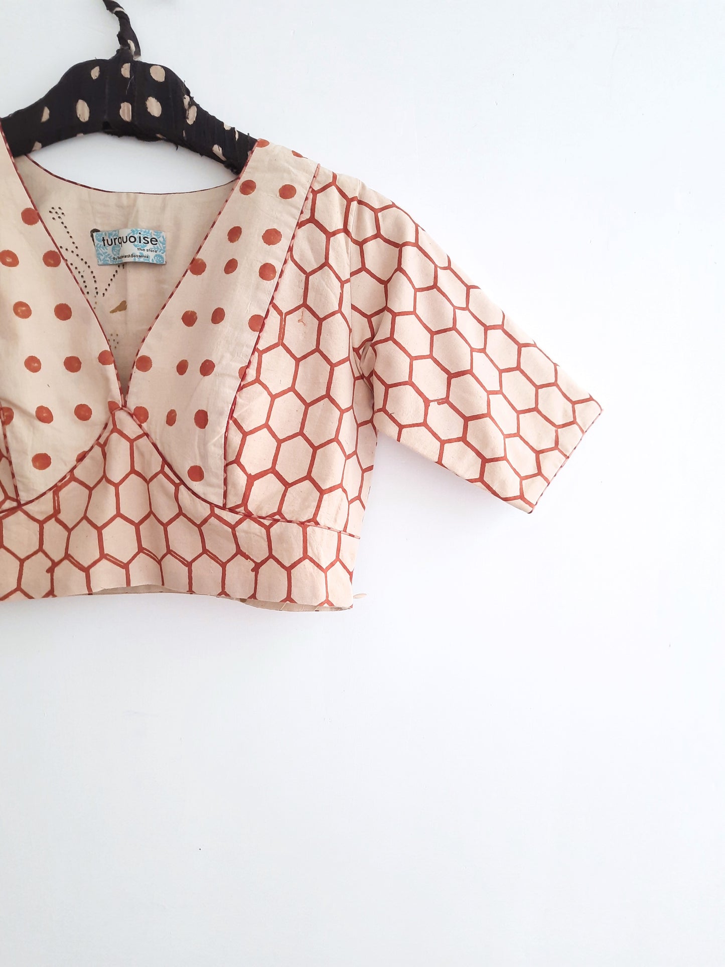 Handmade Ajrakh Blouse: Beige blouse with honeycomb and polka dot prints from Turquoisethestore, showcasing artisanal craftsmanship and natural dyes.