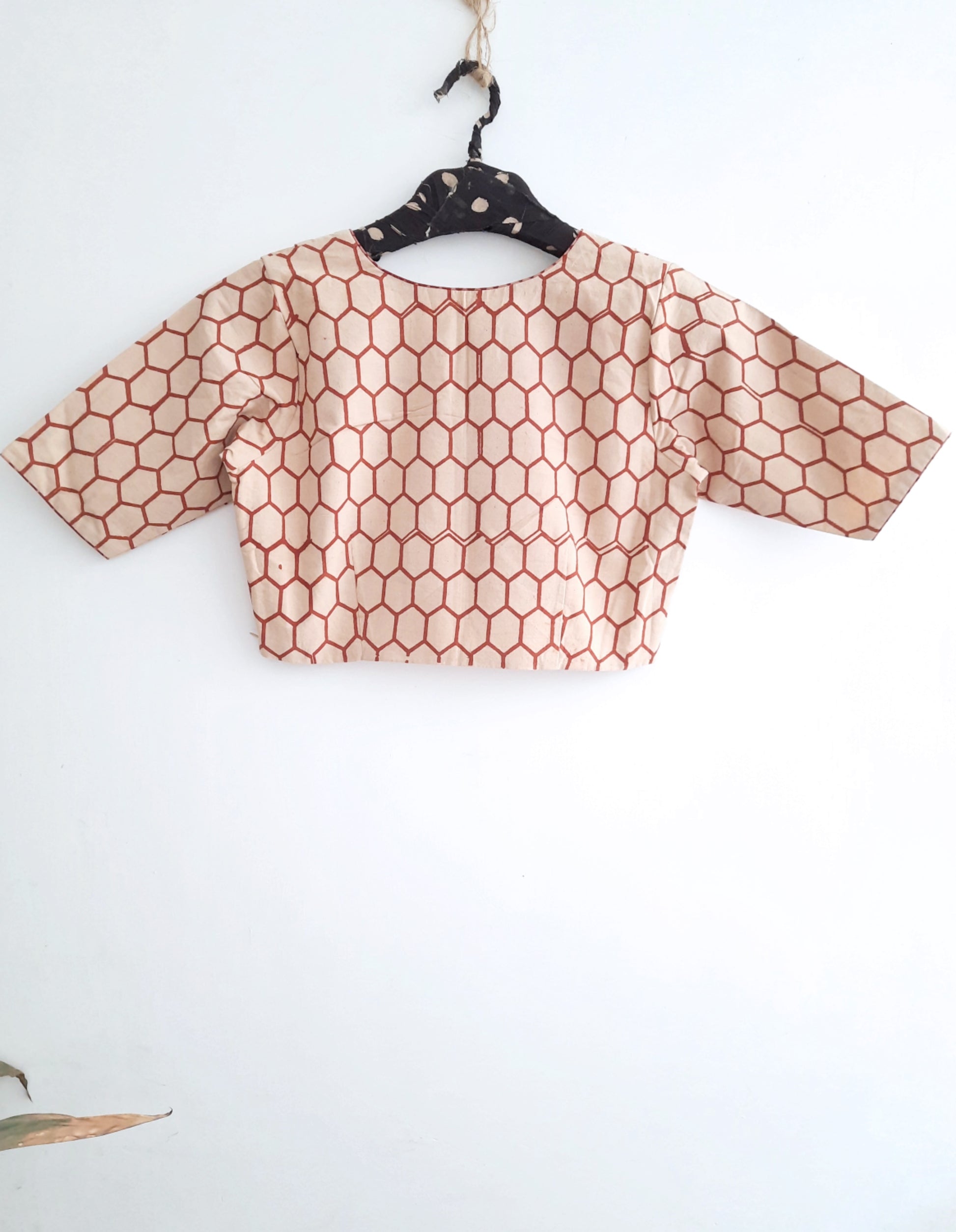 Handmade Ajrakh Blouse: Beige blouse with honeycomb and polka dot prints from Turquoisethestore, showcasing artisanal craftsmanship and natural dyes.