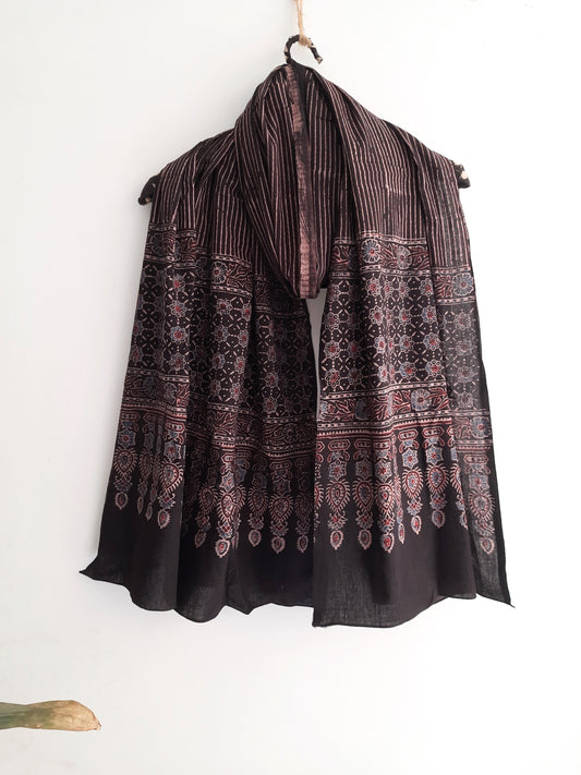 Handmade Ajrakh hand block printed cotton dupatta in checks print, dyed using natural resources. Expertly crafted by artisans in India, this artisanal accessory combines traditional techniques with sustainable practices, adding a touch of heritage to your style.