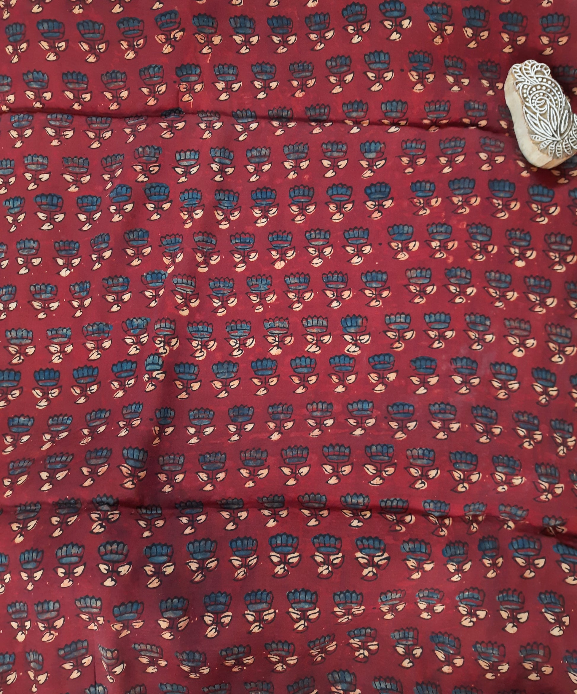 Experience luxury with this Madder-Dyed Maroon Ajrakh Hand Block Printed Modal Silk Fabric. This fabric is expertly crafted using traditional techniques of ajrakh hand block printing and natural dyeing. With its rich madder dye and artisanal quality, this fabric is sure to elevate your wardrobe and create a statement of elegance and sophistication.