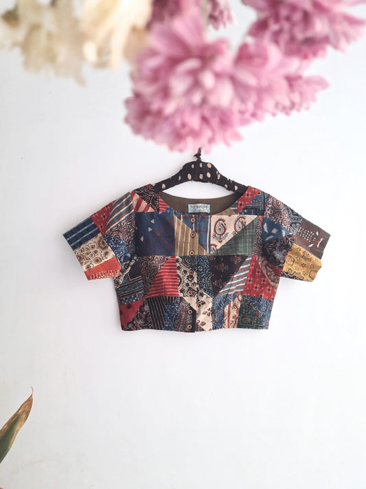 Captivating Multi-Ajrakh Hand Block Prints Patchwork Blouse from Turquoisethestore. Pure cotton, vibrant natural dyes – a sustainable fashion statement merging tradition and style for your eco-conscious wardrobe.