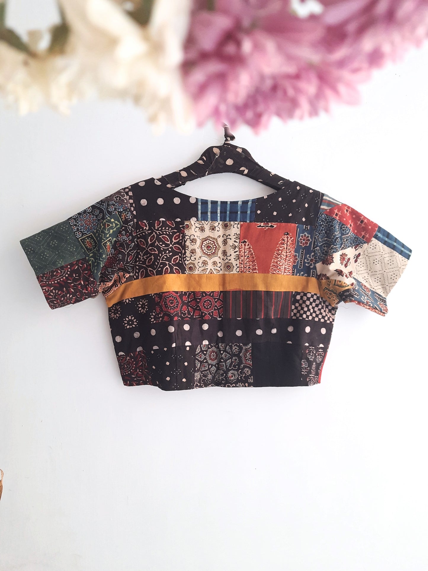 Captivating Multi-Ajrakh Hand Block Prints Patchwork Blouse from Turquoisethestore. Pure cotton, vibrant natural dyes – a sustainable fashion statement merging tradition and style for your eco-conscious wardrobe.