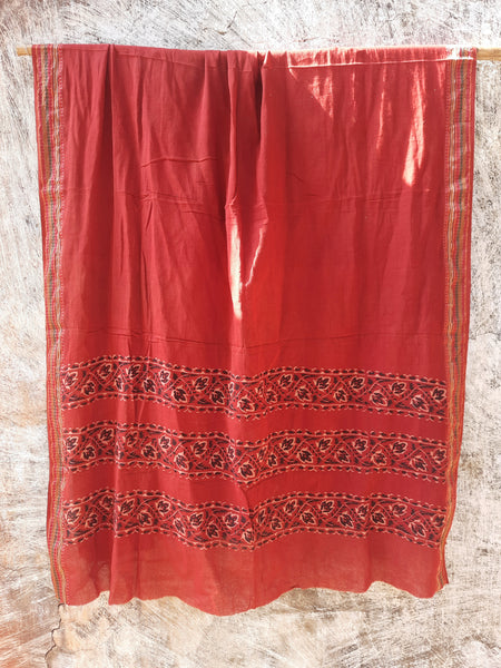 Madder-dyed pure cotton dupatta featuring intricate Ajrakh hand block printed borders. Crafted mindfully and naturally dyed, this lightweight and breathable dupatta adds a touch of Indian tradition to any outfit. Perfect for festive or everyday wear.