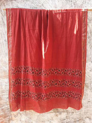 Madder-dyed pure cotton dupatta featuring intricate Ajrakh hand block printed borders. Crafted mindfully and naturally dyed, this lightweight and breathable dupatta adds a touch of Indian tradition to any outfit. Perfect for festive or everyday wear.