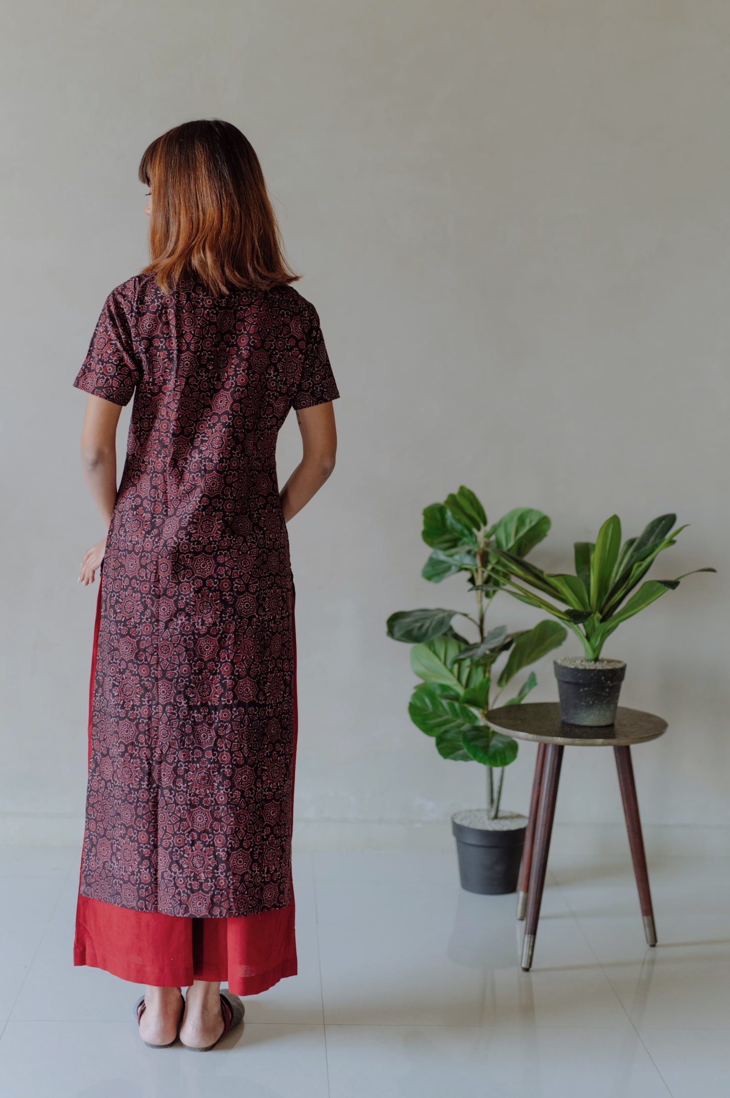 Elevate your everyday style with our Black and Madder Ajrakh Kurta Pants Set. Made from pure cotton, hand block printed with natural dyes for a timeless look. The mandarin collar kurta and elasticated waist band pants provide ultimate comfort. Upgrade your wardrobe with this beautiful and breathable set.