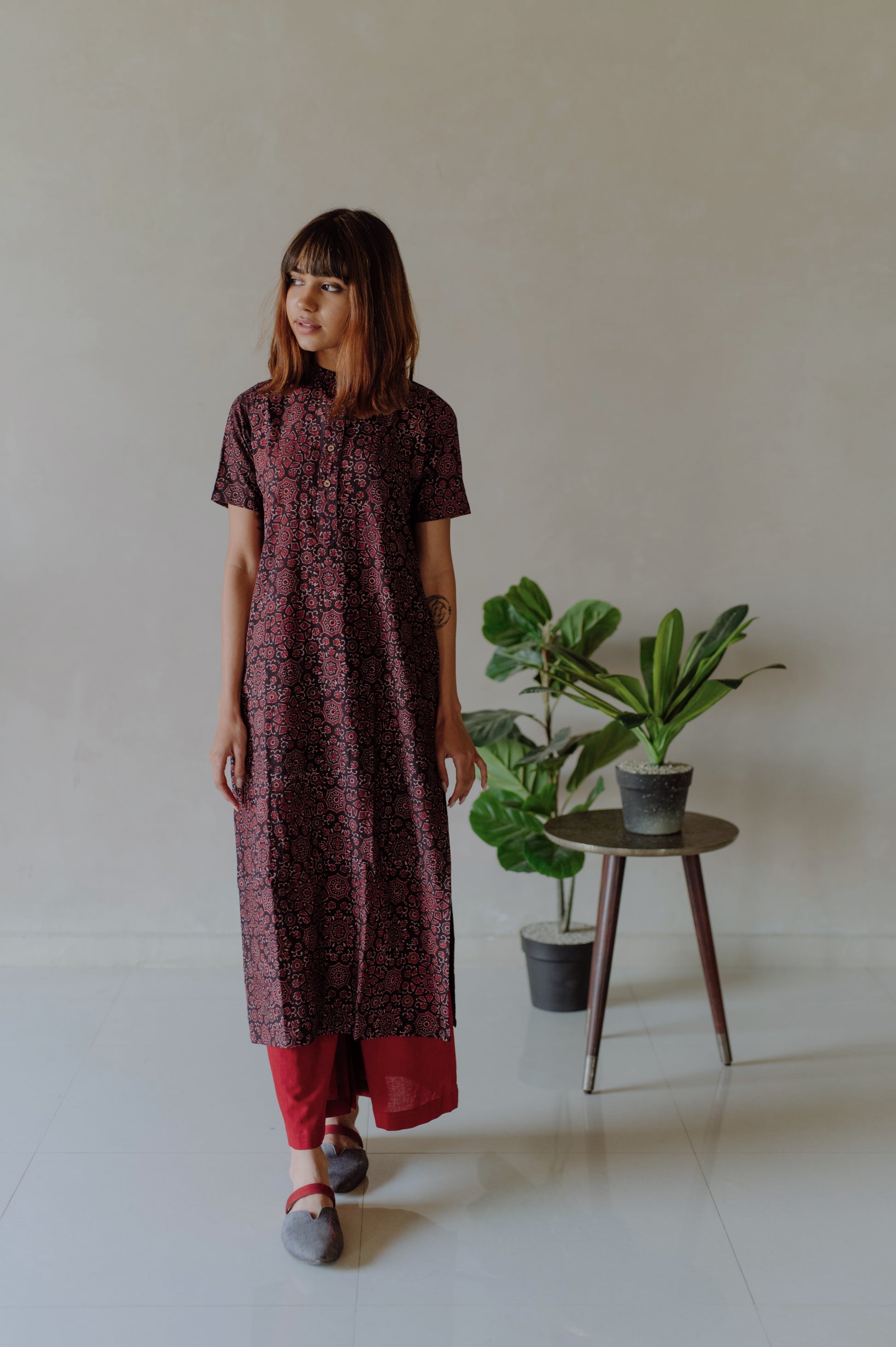 Elevate your everyday style with our Black and Madder Ajrakh Kurta Pants Set. Made from pure cotton, hand block printed with natural dyes for a timeless look. The mandarin collar kurta and elasticated waist band pants provide ultimate comfort. Upgrade your wardrobe with this beautiful and breathable set.