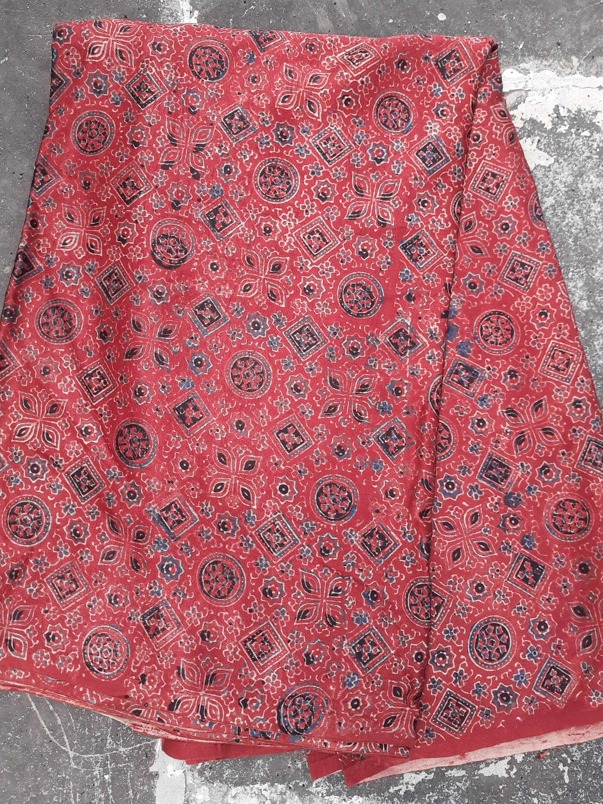 Ajrakh hand block print mashru silk fabric in madder red color.