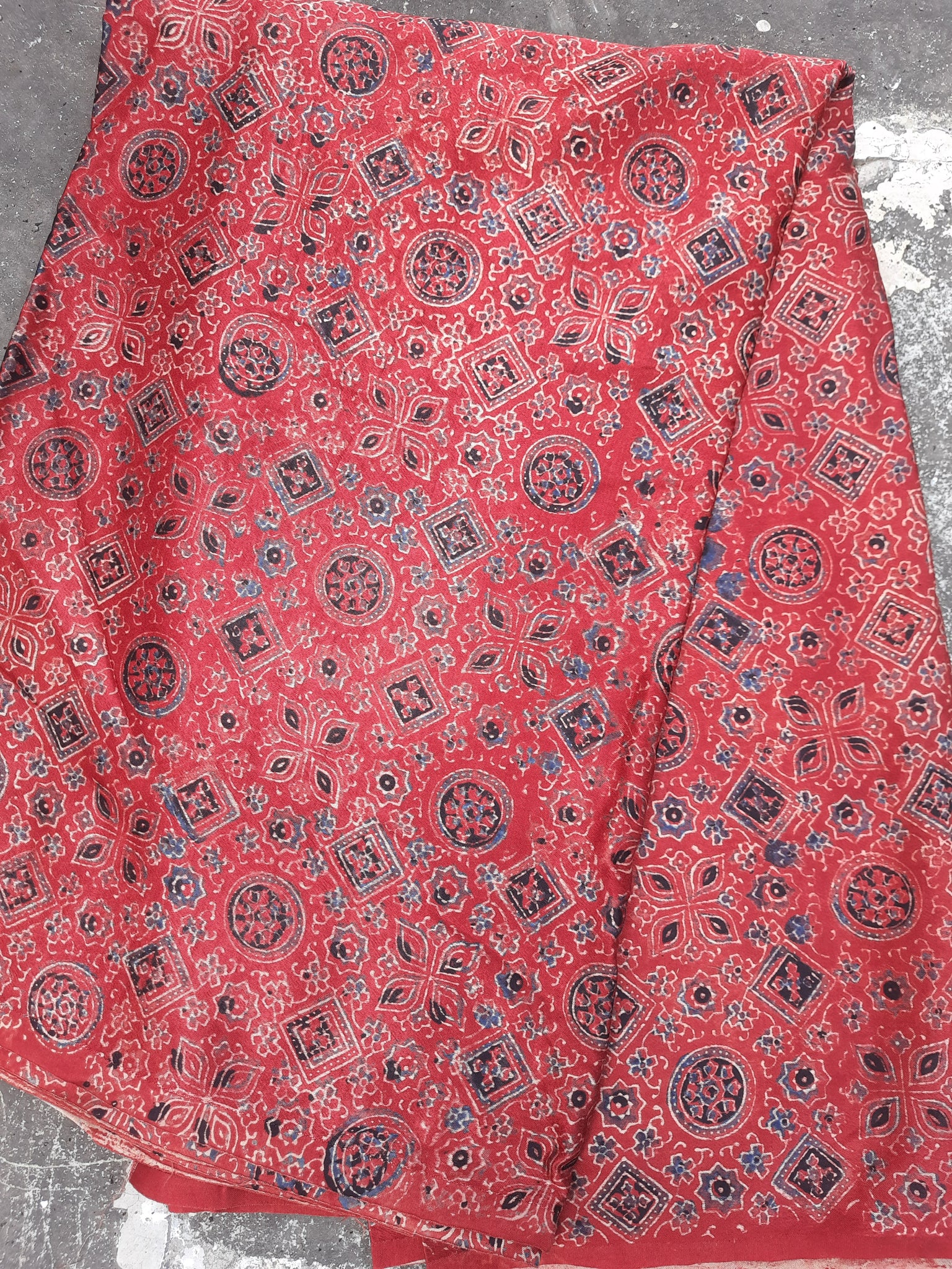 Ajrakh hand block print mashru silk fabric in madder red color.