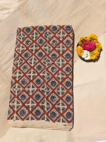 Handmade beige Ajrakh cotton fabric, 44 inches wide, naturally dyed and ethically crafted by Indian artisans. Perfect for garments, home décor, and sustainable fashion. Intricate hand block printed patterns showcase traditional craftsmanship and eco-friendly artistry.