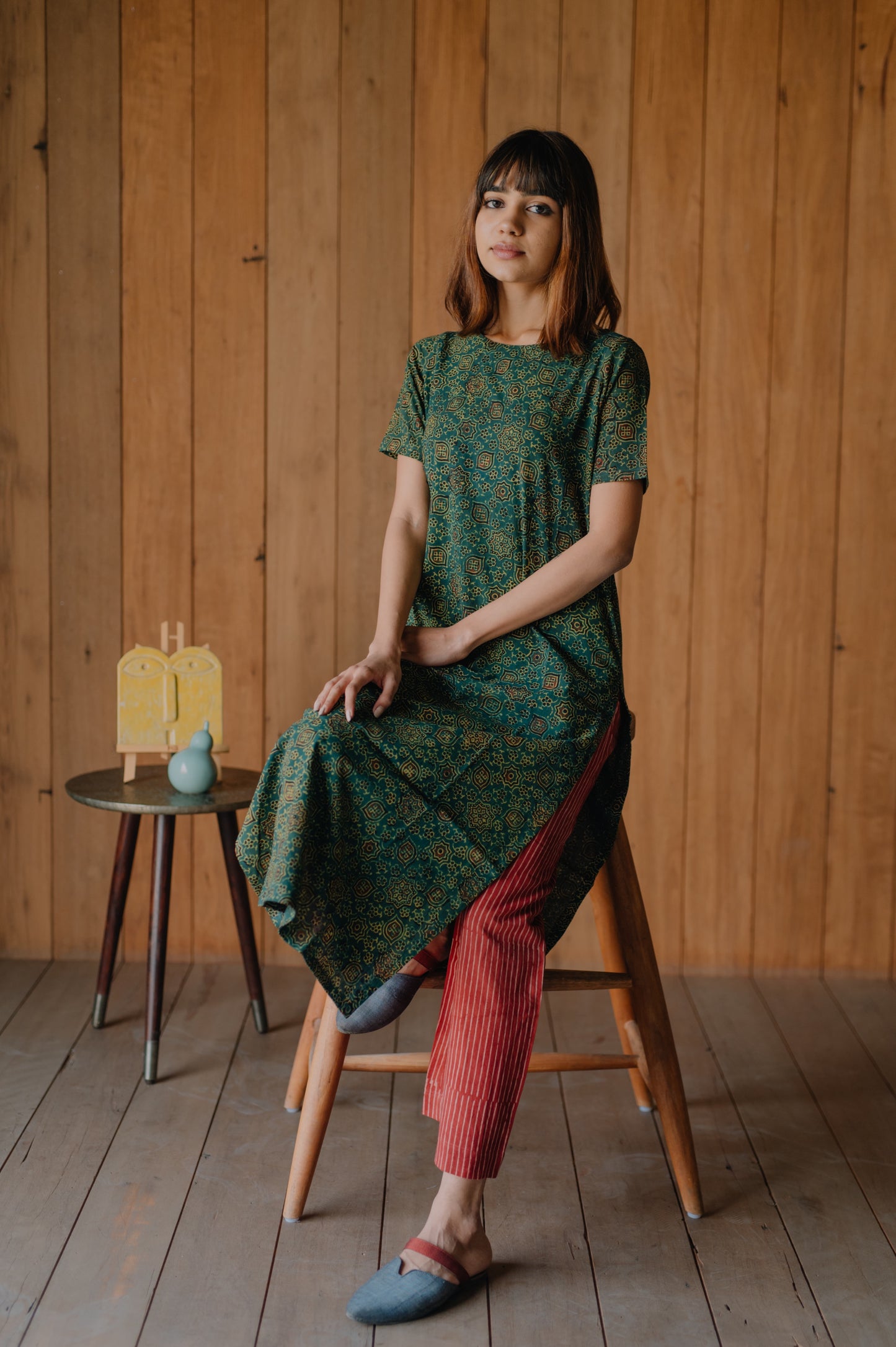 Step into style and comfort with our Natural Hues Pant Set. The Ajrakh hand block print on the green kurta perfectly complements the stripes madder dyed pants, delivering a unique and eye-catching look. The elasticated waistband and breathable fabric make this set perfect for everyday wear.