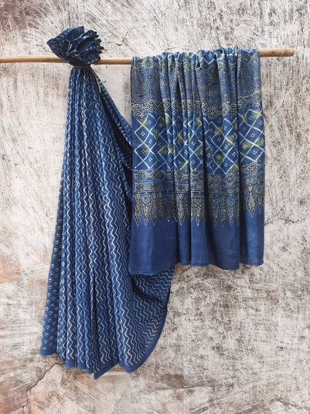 Indigo Ajrakh hand block printed saree in pure cotton, crafted with natural dyes. Elegant 6.3-meter saree with traditional patterns and a running blouse.