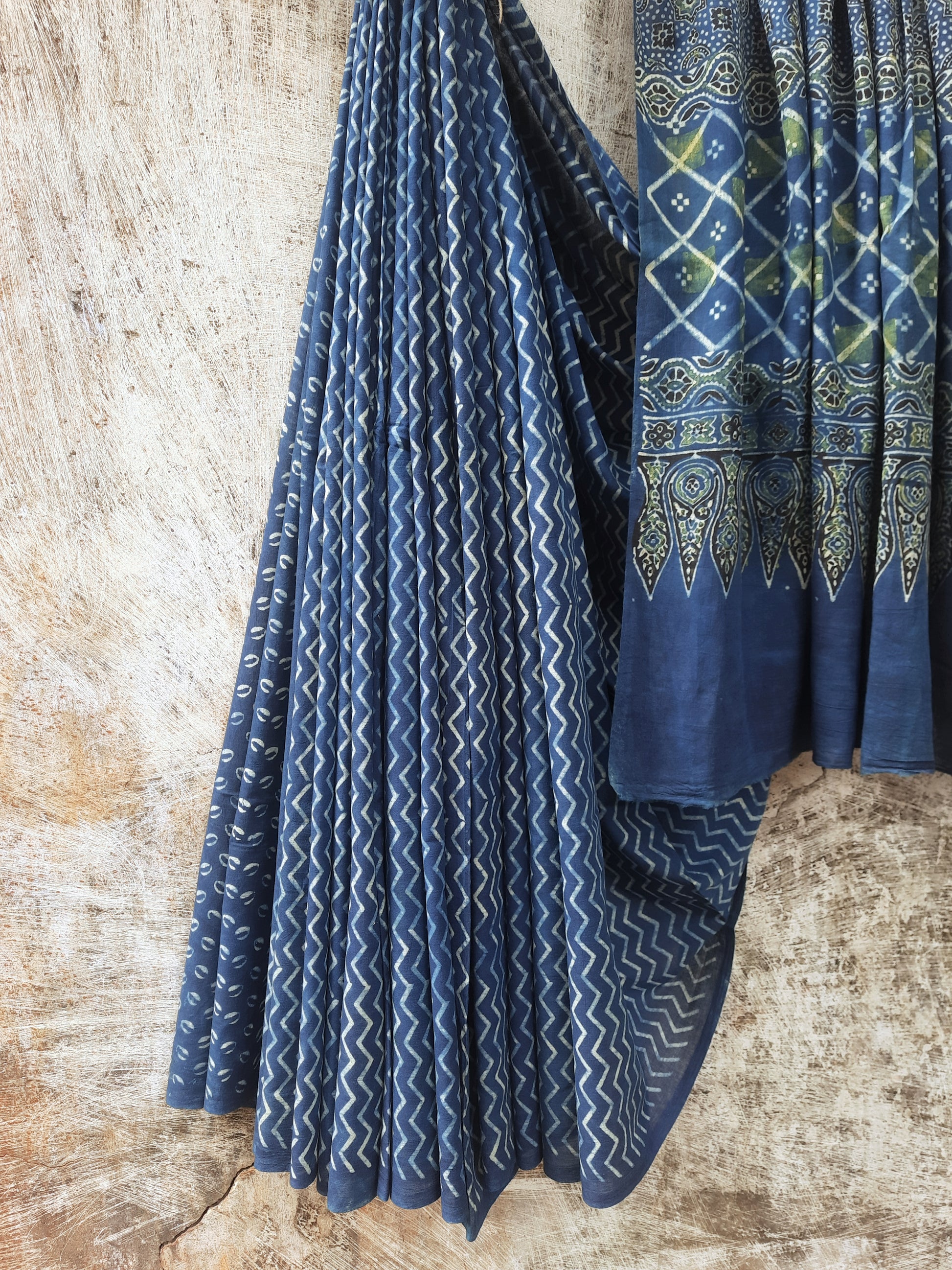 Indigo Ajrakh hand block printed saree in pure cotton, crafted with natural dyes. Elegant 6.3-meter saree with traditional patterns and a running blouse.