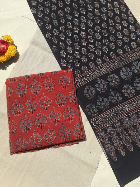 Handcrafted Ajrakh suit set in pure cotton, featuring intricate hand block prints and natural madder dye. Paired with a black dupatta, slow-made, breathable, and eco-friendly.