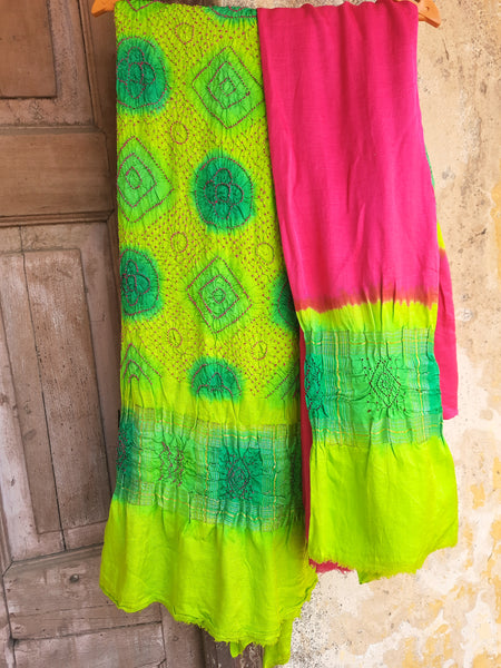 Handcrafted green and pink Rai Dani Bandhani 3-piece suit set in Gajji silk. Includes unstitched top, bottom, and dupatta with subtle zari borders. Traditional Indian wear.