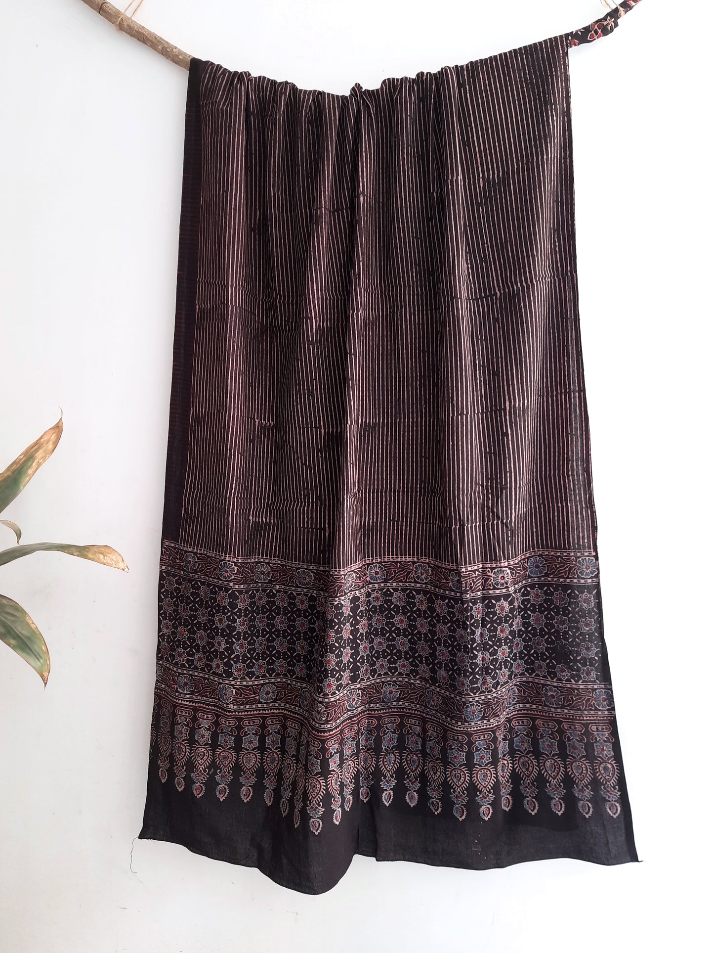 Handmade Ajrakh hand block printed cotton dupatta in checks print, dyed using natural resources. Expertly crafted by artisans in India, this artisanal accessory combines traditional techniques with sustainable practices, adding a touch of heritage to your style.