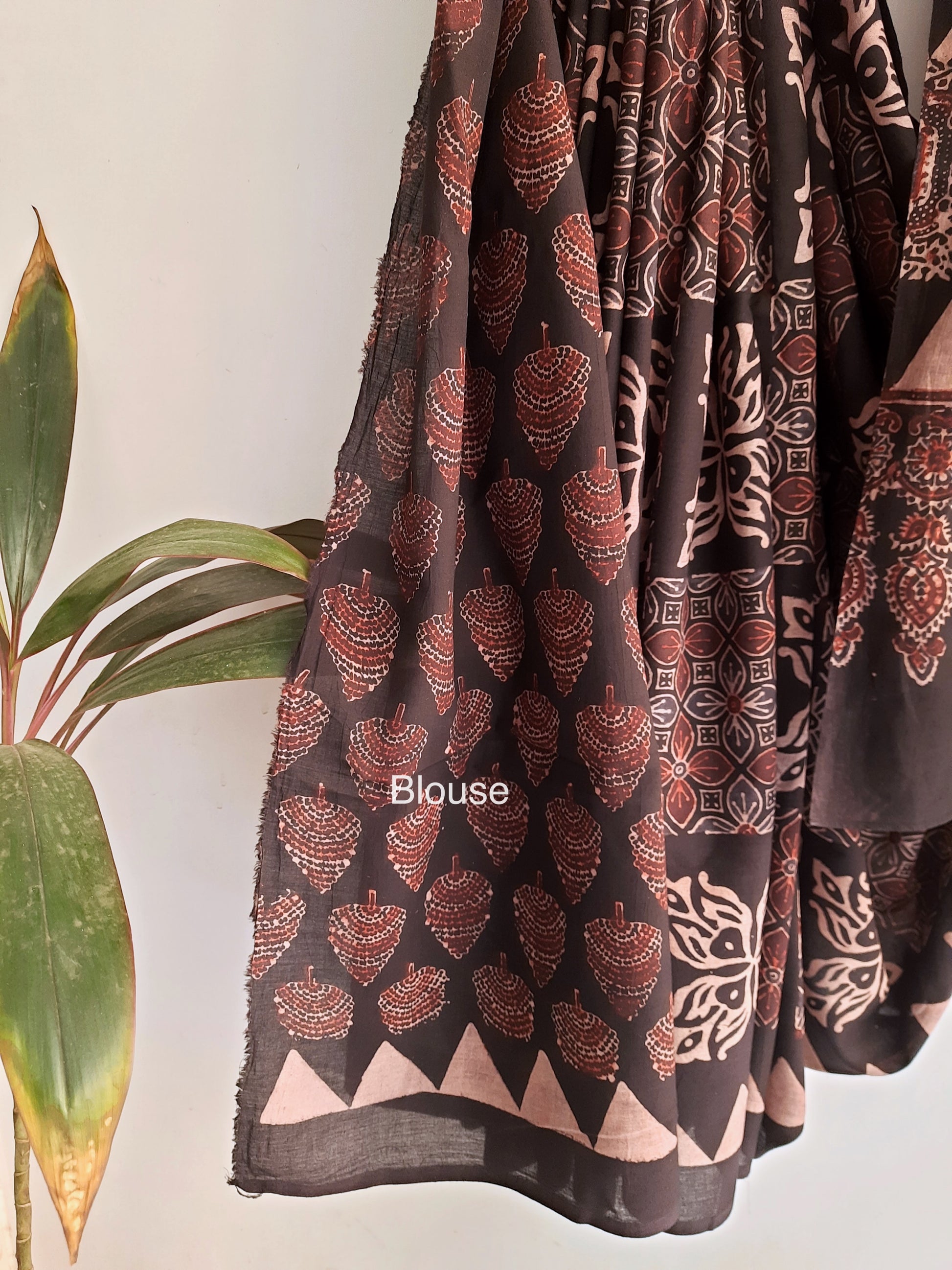 Charcoal Black Ajrakh Saree, combining artisanal expertise with natural dyes and hand block printing. Made from pure cotton, it offers both style and comfort. Slow made and conscious, it's a tasteful addition to your collection. Includes a running blouse for a complete, luxurious look.