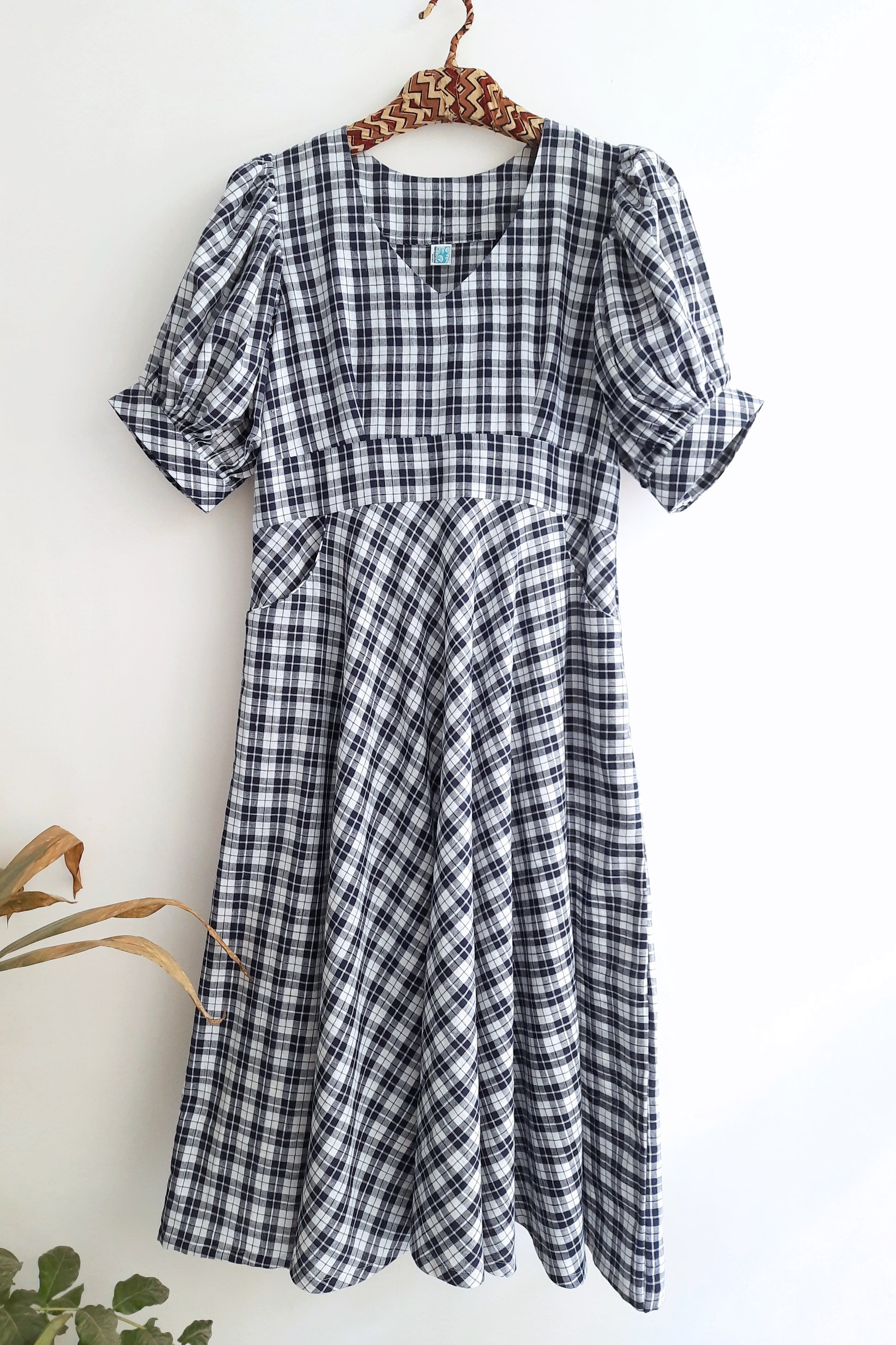 Checkered Dress in Blue & White color for women with V-neck, puffy sleeves, and front pockets, made from sustainable cotton.
