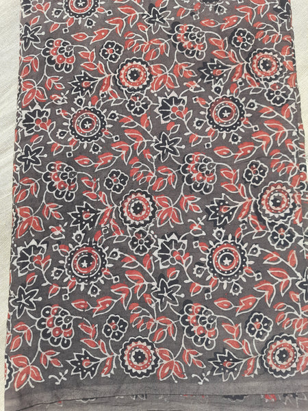 Earthy brown Ajrakh hand block printed fabric in pure cotton, crafted using natural dyes. Featuring intricate floral motifs, eco-friendly, breathable, and artisan-made. Traditional Indian textile, slow-made and consciously crafted. Width: 44 inches.