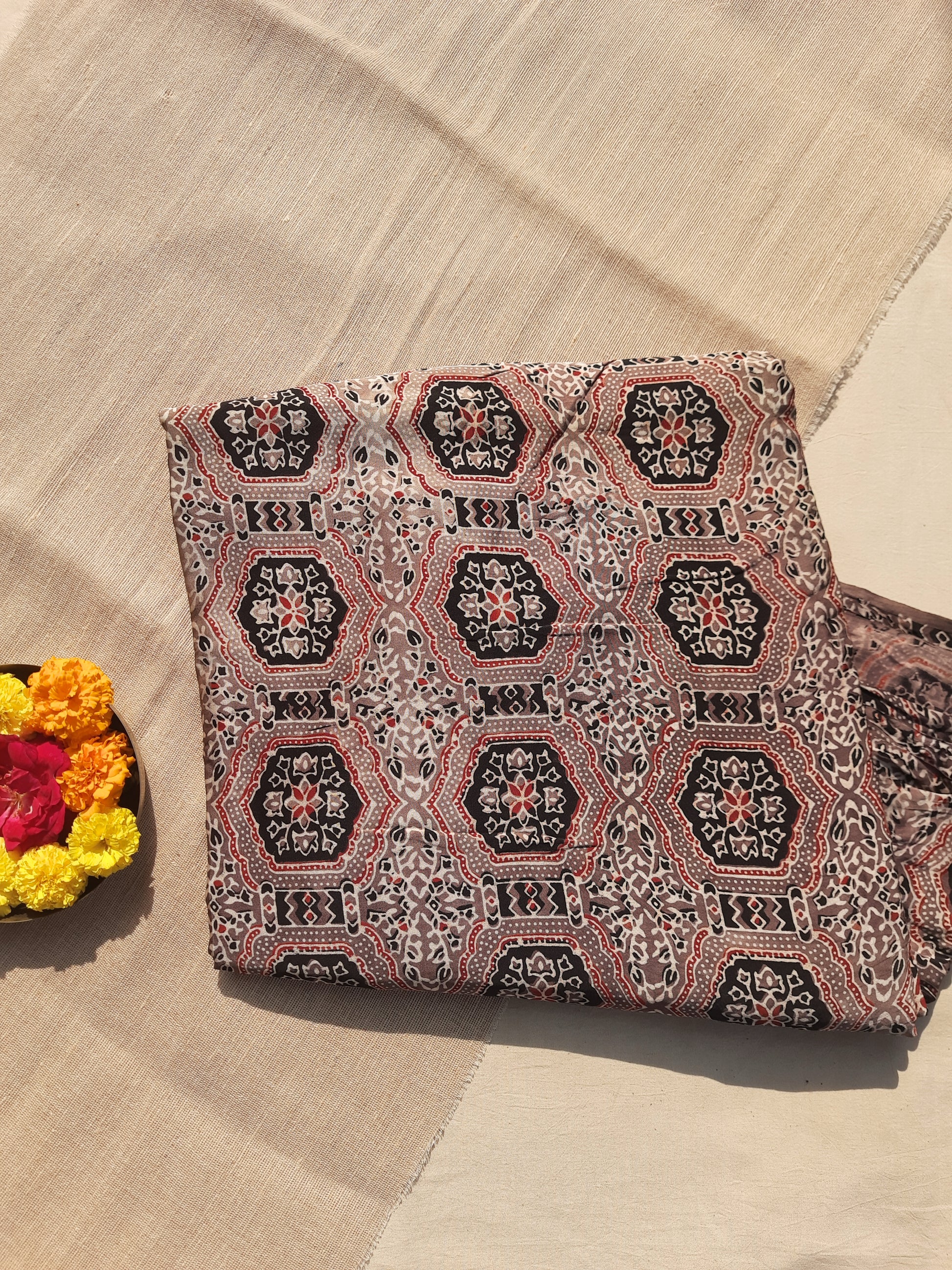 Earthy brown Ajrakh hand block printed modal silk fabric, 46-inch wide, naturally dyed, handcrafted by artisans. Luxurious, eco-friendly yardage perfect for elegant garments, accessories, and sustainable craft projects. Authentic and slow-made craftsmanship.