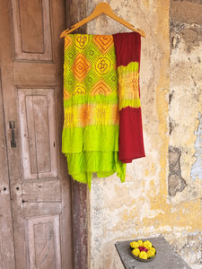 Handcrafted green and maroon Rai Dani Bandhani 3-piece suit set in Gajji silk. Features unstitched top, bottom, and dupatta with subtle zari borders. Traditional Indian wear.