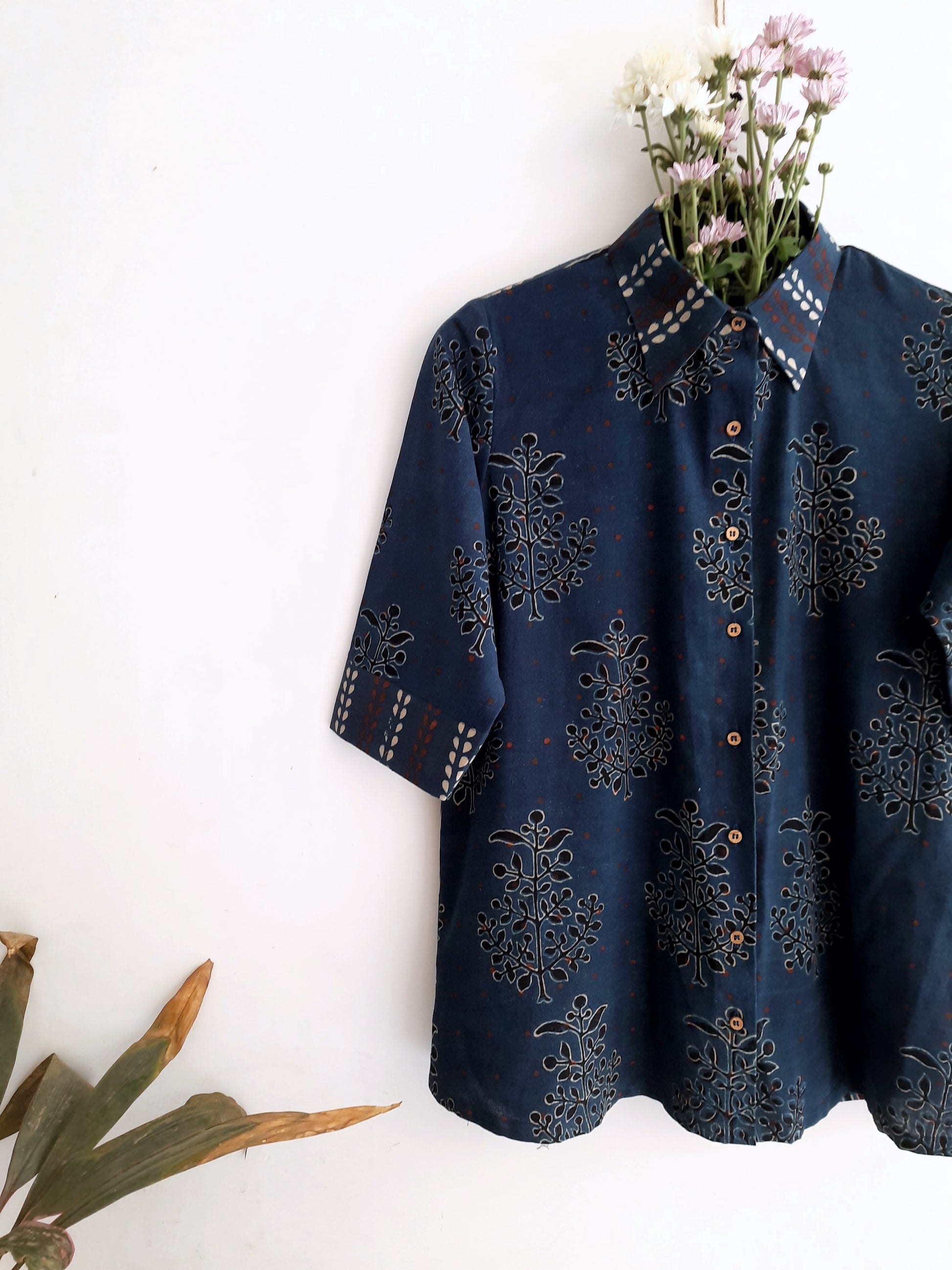 Image: Breezy Indigo Ajrakh Fusion shirt for women, featuring hand block prints in polkas, bootas, and stripes. Crafted with care, this indigo dyed shirt adds artisanal charm to any wardrobe. Shop now at Turquoisethestore.