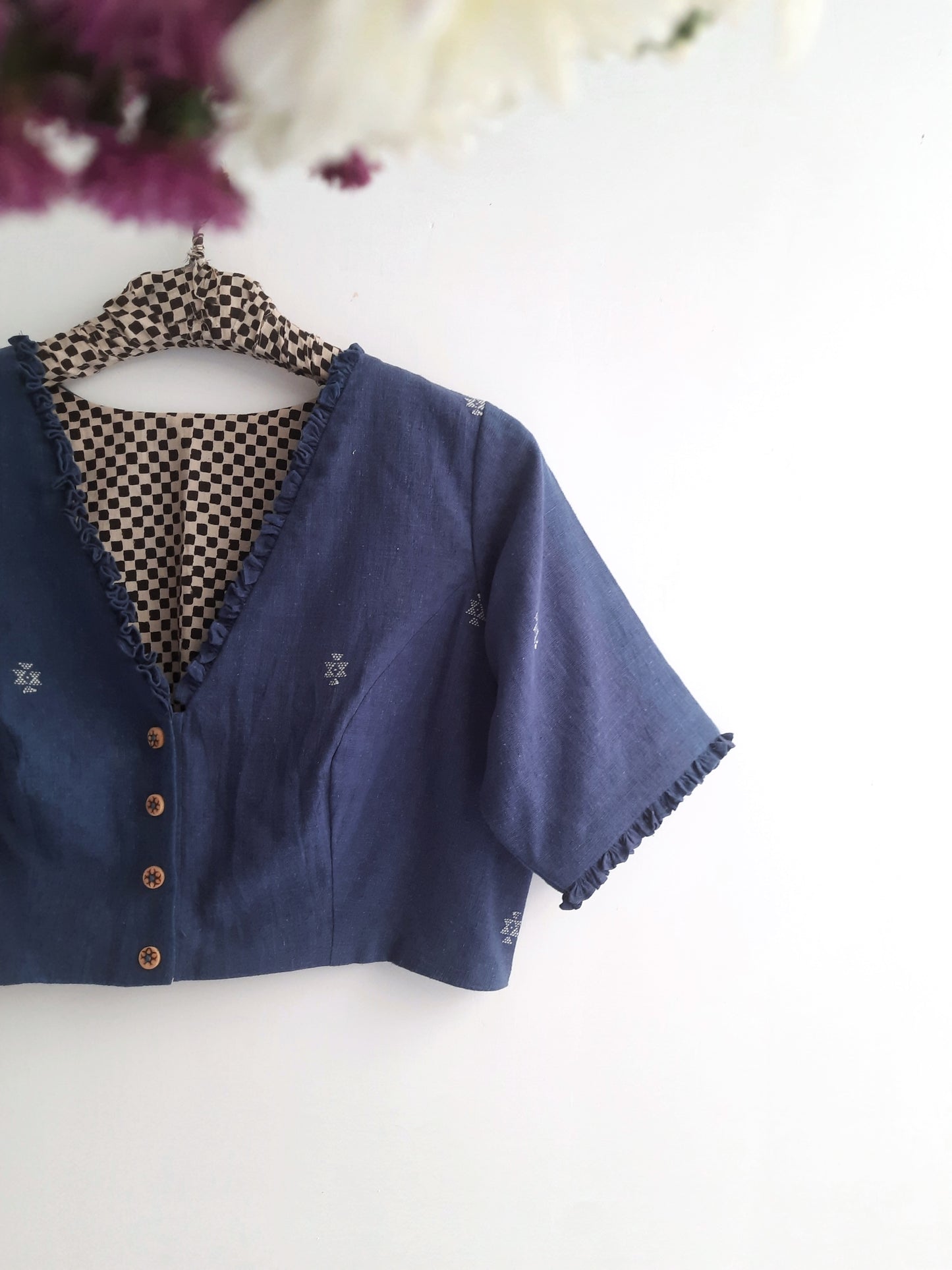 Beautifully crafted indigo-dyed organic cotton saree blouse, showcasing intricate hand-spun details and vibrant, natural hues.