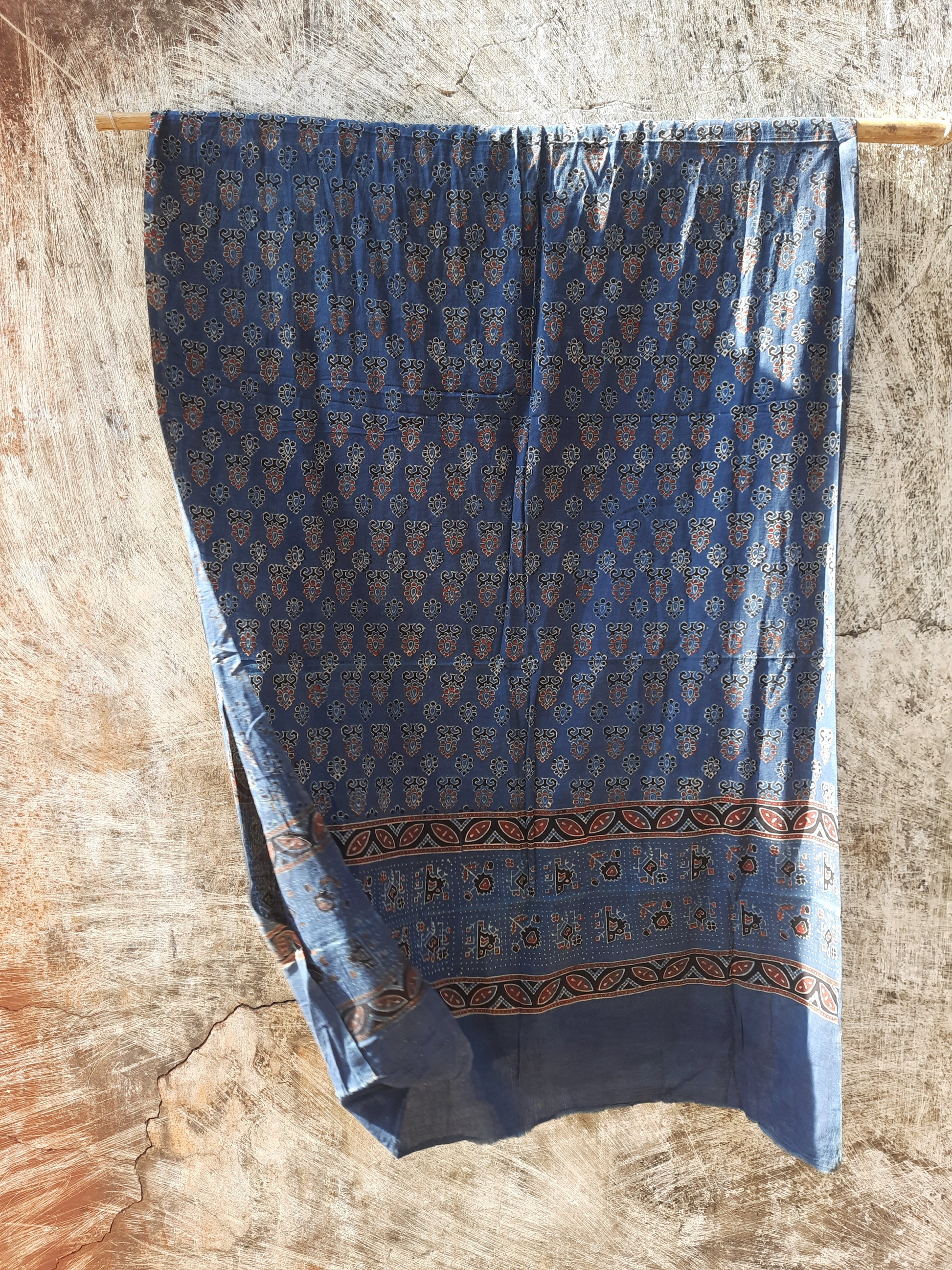 Handcrafted Indigo Dyed Ajrakh Cotton Dupatta with natural dyes and hand block printed borders. Ethically crafted, this eco-friendly, comfortable dupatta is perfect for adding a traditional, artisanal touch to your outfit. Ideal for cotton lovers and sustainable fashion enthusiasts.