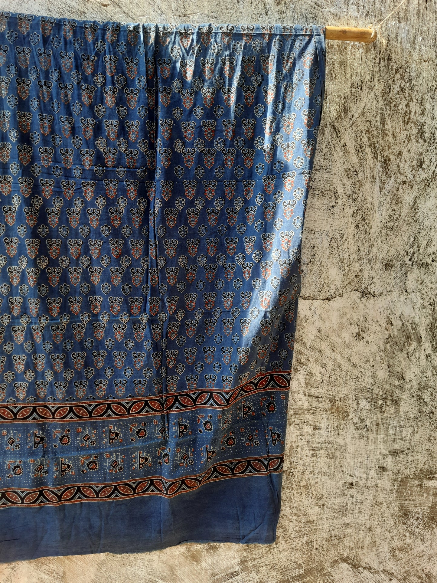 Handcrafted Indigo Dyed Ajrakh Cotton Dupatta with natural dyes and hand block printed borders. Ethically crafted, this eco-friendly, comfortable dupatta is perfect for adding a traditional, artisanal touch to your outfit. Ideal for cotton lovers and sustainable fashion enthusiasts.