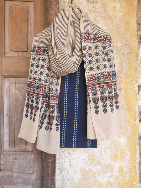 Ajrakh hand block printed two-piece suit set in pure cotton, featuring an indigo booti print top and a Myrobalan-dyed dupatta with traditional motifs. Naturally dyed, eco-friendly, and handcrafted by artisans for a timeless ethnic look.