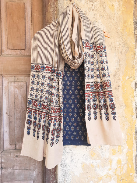 Ajrakh hand block printed two-piece suit set in pure cotton, featuring indigo small booti print and Myrobalan-dyed dupatta with traditional motifs. Eco-friendly, naturally dyed, and handcrafted ethnic wear.