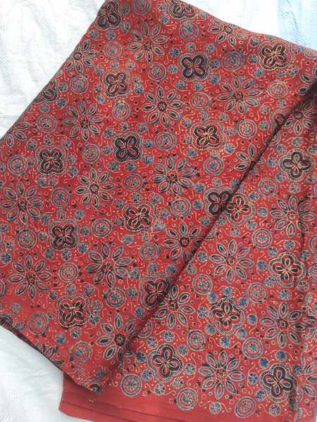 Madder red ajrakh hand block print mashru silk fabric.