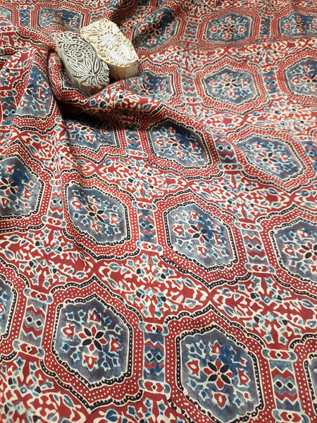 Indulge in luxury with our handmade fabrics. Using traditional techniques, our exquisite modal silk fabric is madder-dyed and hand block printed with the intricate designs of Ajrakh. Each piece is artisan crafted, offering a sustainable addition to your wardrobe. Experience the softness and elegance with every wear.