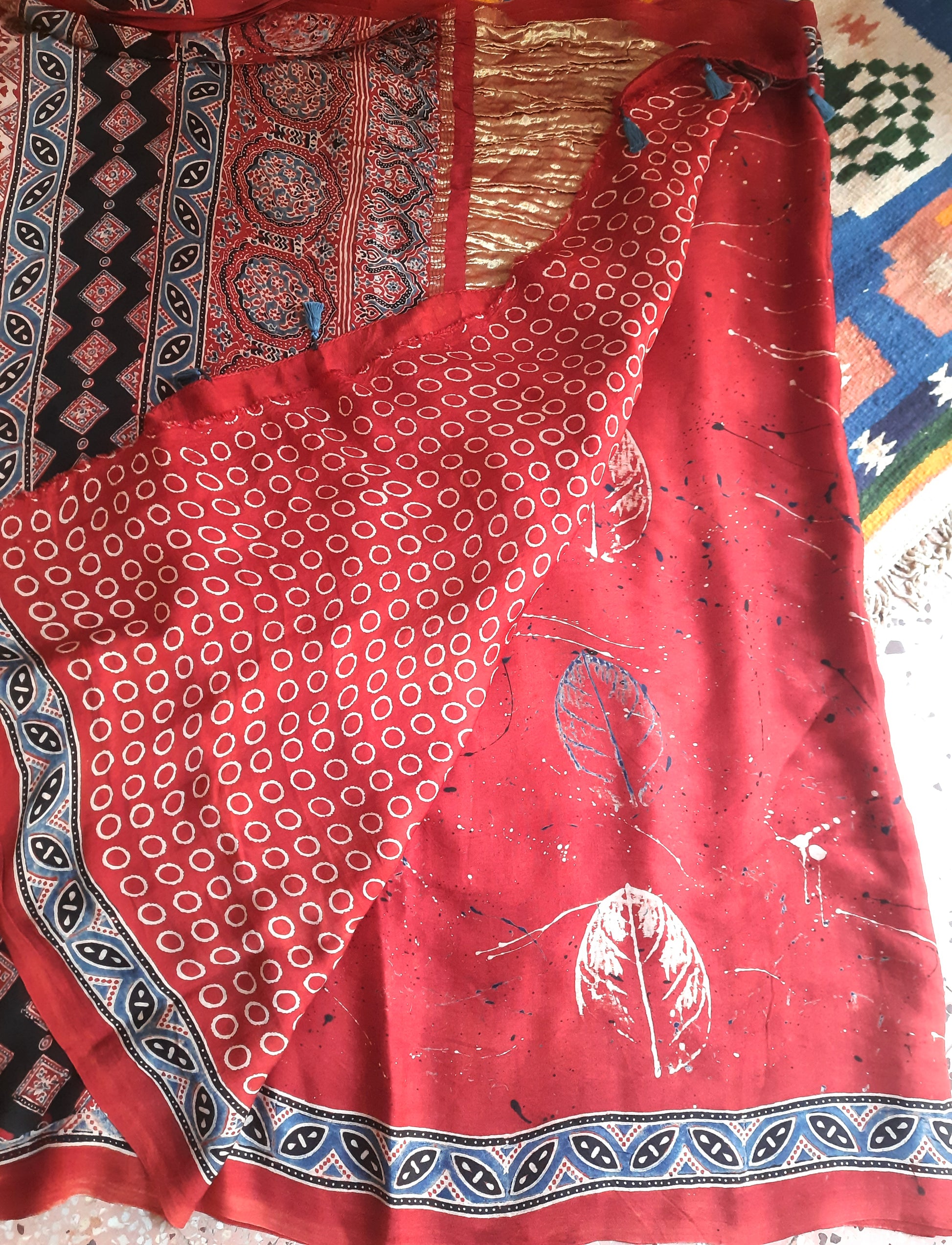 Madder-dyed Ajrakh hand block printed saree in soft and luxurious modal silk. Features eco-prints on the body, Ajrakh prints on the pallu and blouse. Naturally dyed and handcrafted by Indian artisans in Gujarat. Perfect for traditional saree lovers.