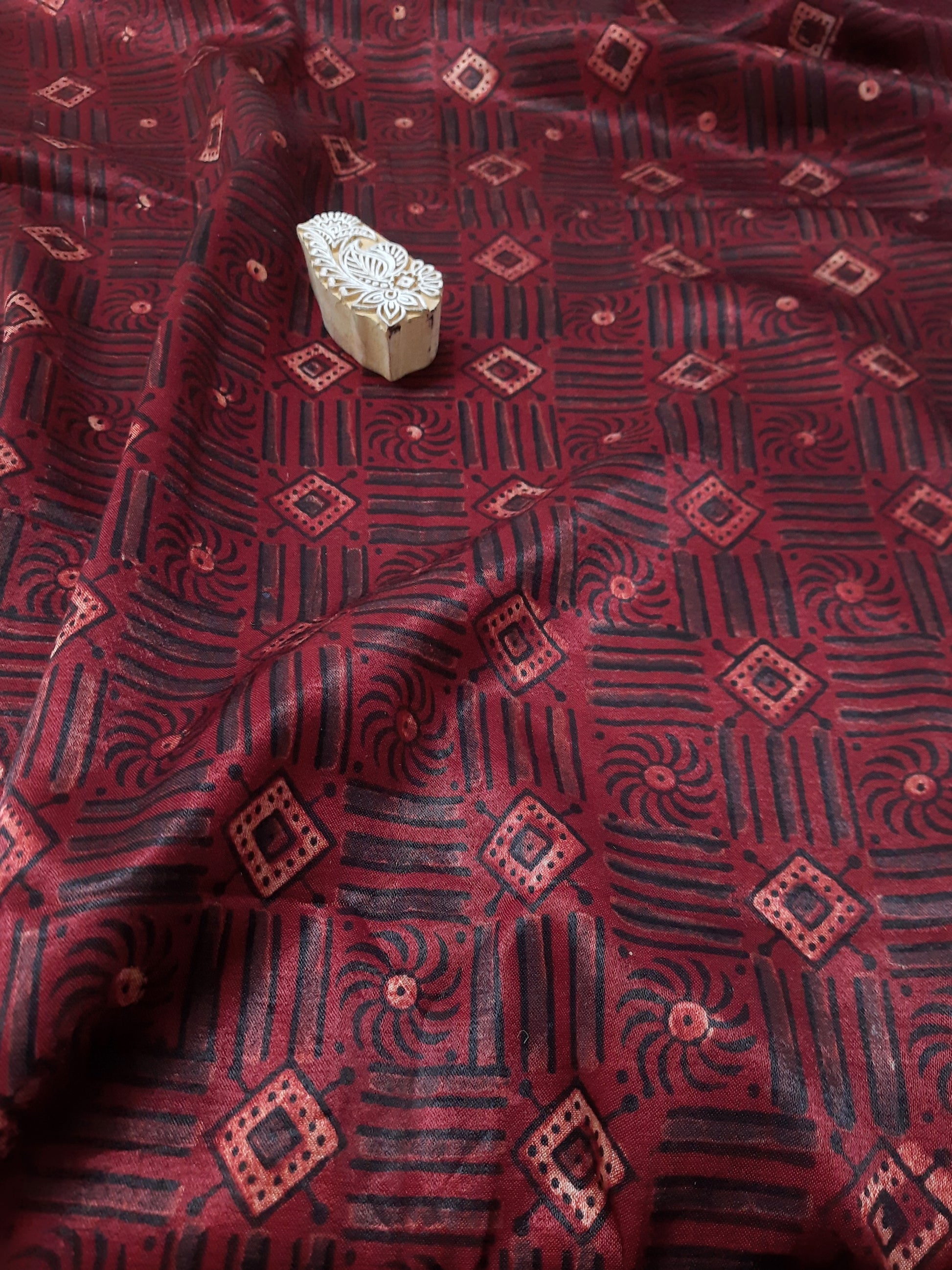 Indulge in the luxurious feel of Mashru silk, hand block printed with traditional Ajrakh designs and madder dyed by skilled artisans. This fabric is the perfect addition to your eco-conscious wardrobe, allowing you to create your own unique and stylish shirt, blouse or kurta. Elevate your fashion game with this beautiful and sustainable fabric.