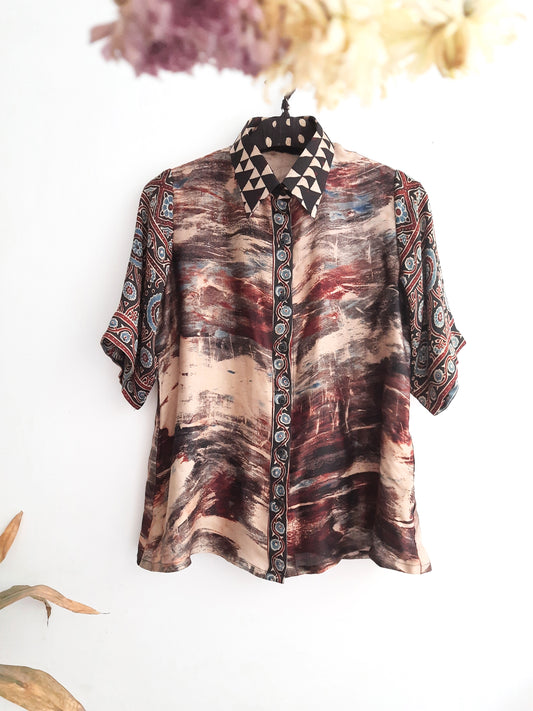 A luxurious modal silk shirt featuring the Dawn to Dusk Mirage print, meticulously crafted with Ajrakh hand block printing and natural dyes. This masterpiece embodies elegance and comfort, inspired by a slow-made approach. Treat yourself to this exclusive work of art from Turquoisethestore.
