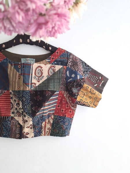 Captivating Multi-Ajrakh Hand Block Prints Patchwork Blouse from Turquoisethestore. Pure cotton, vibrant natural dyes – a sustainable fashion statement merging tradition and style for your eco-conscious wardrobe.