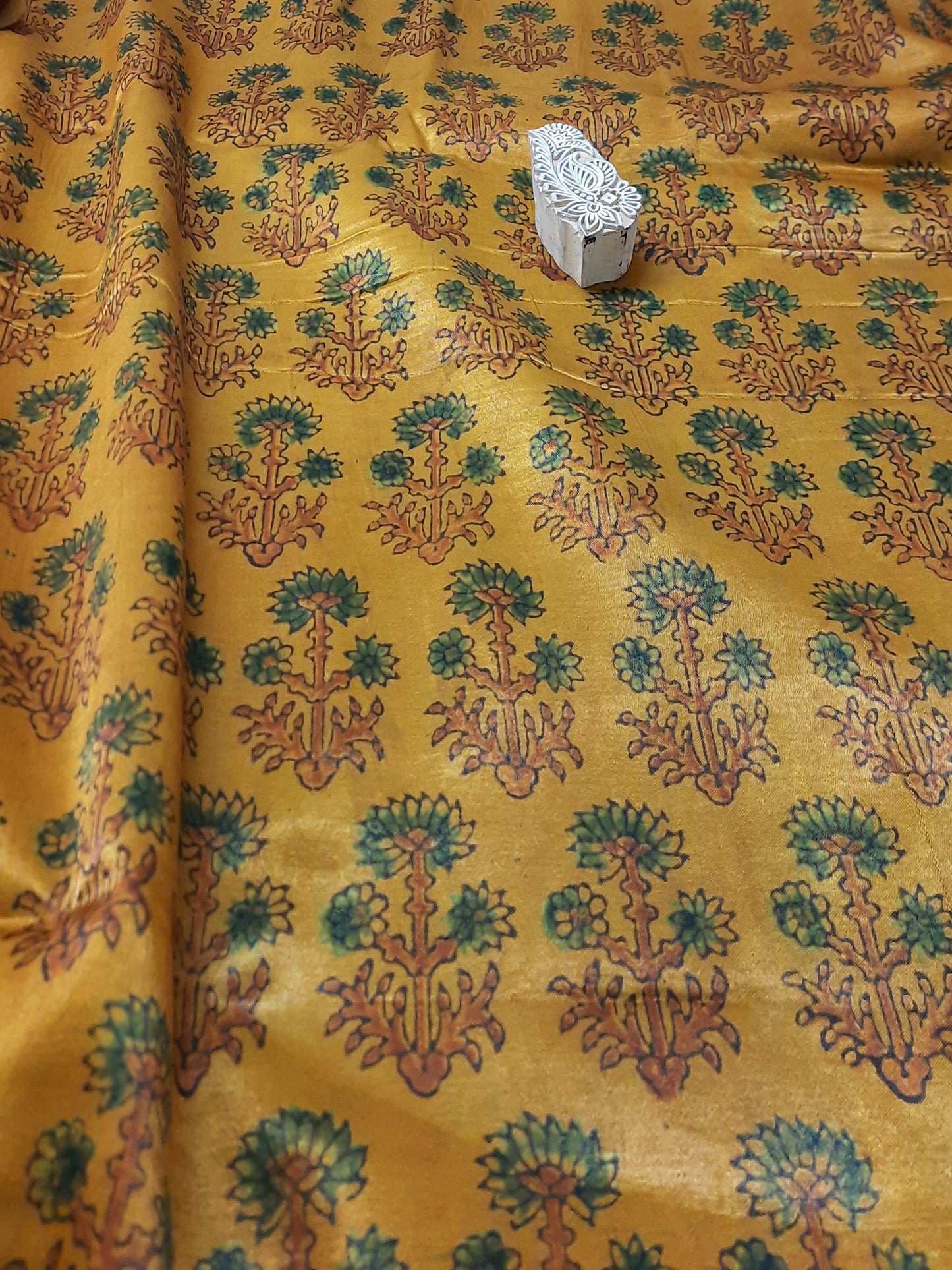 Experience the opulent touch of Mashru silk fabric, adorned with the exquisite ajrakh design. The one-of-a-kind turmeric dye adds to the fabric's charm and promotes sustainable fashion. Create your own stunning design with our eco-friendly, luxurious fabric for an elegant aesthetic.