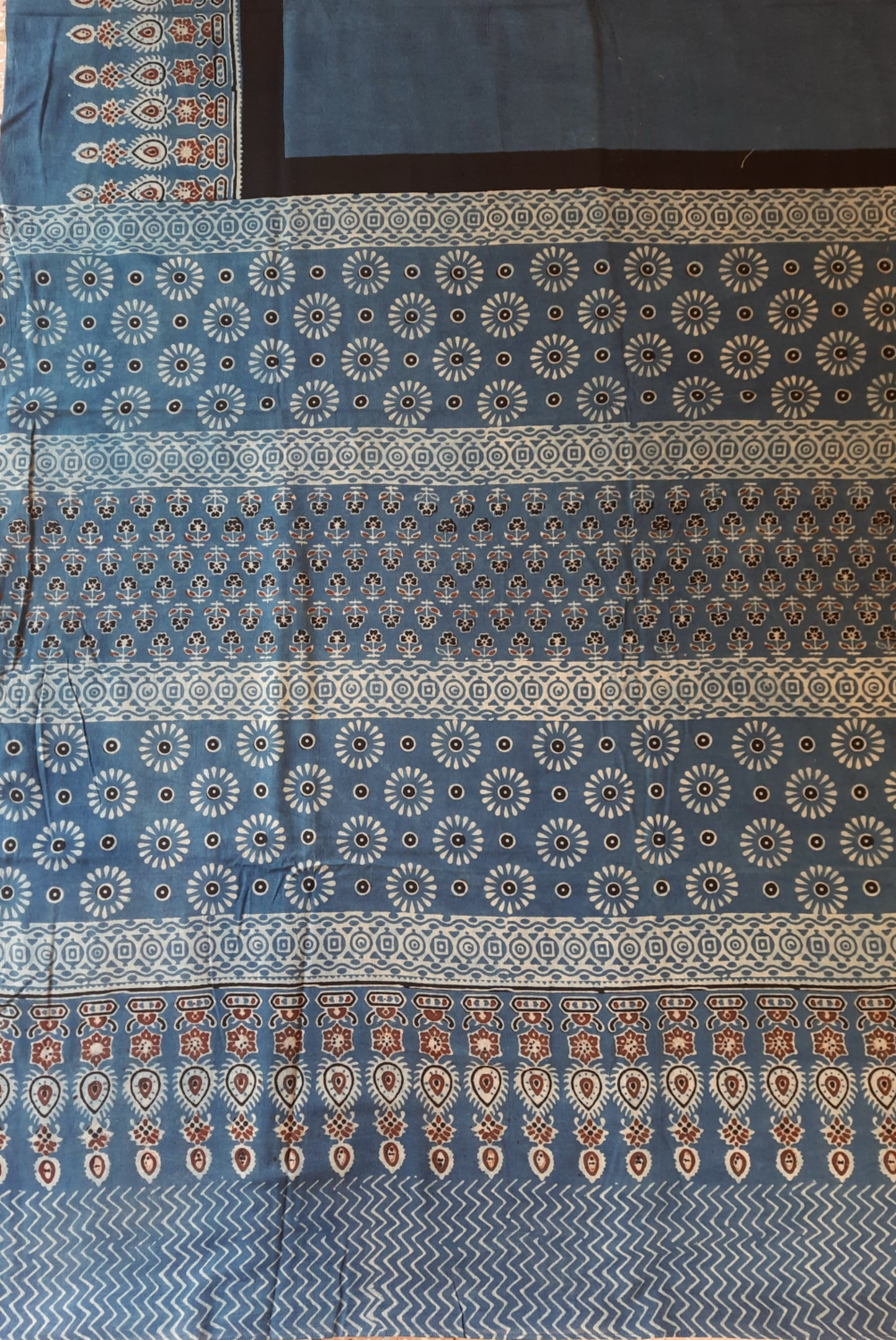 Indigo Ajrakh hand block printed saree in pure cotton, naturally dyed and ethically crafted in India, featuring breathable fabric for sustainable fashion.