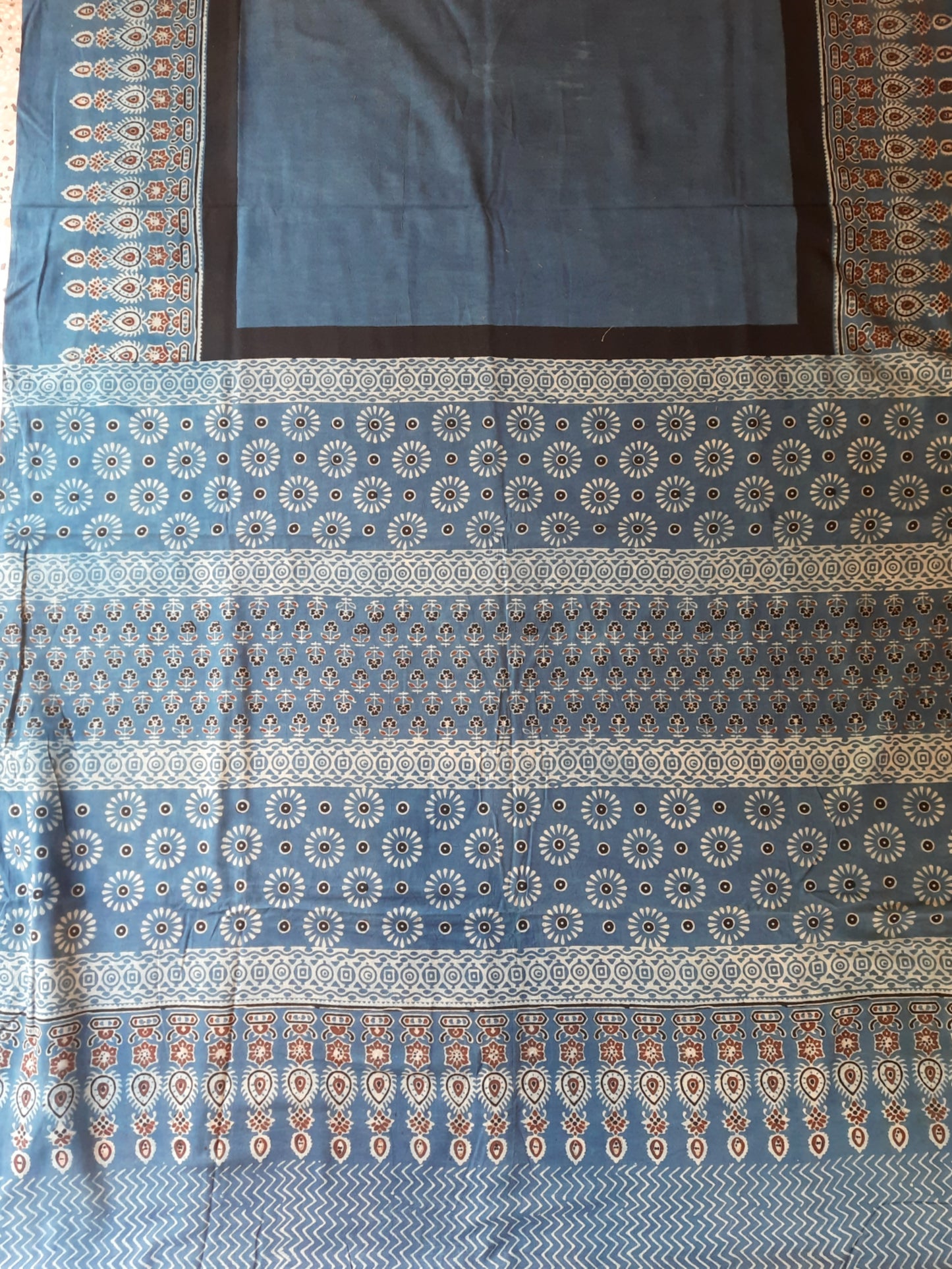 Indigo Ajrakh hand block printed saree in pure cotton, naturally dyed and ethically crafted in India, featuring breathable fabric for sustainable fashion.