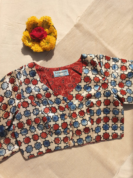 Handcrafted Ajrakh Mashru silk blouse, naturally dyed and hand block printed. Features a curved V-neck, round back, front button closure, and madder Ajrakh cotton lining. Ethnic Indian wear with 2-inch margin for adjustments. Perfect for sarees and traditional outfits.