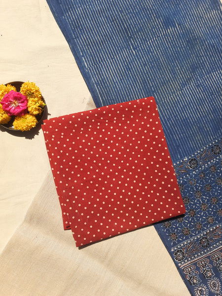 Handcrafted Ajrakh suit set in pure cotton with madder-dyed polka dots and an indigo-striped dupatta. Naturally dyed, breathable, and slow-made, showcasing intricate hand block printing. Perfect for Indian ethnic wear and sustainable fashion lovers.