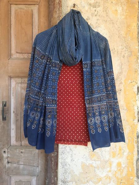 Handcrafted Ajrakh suit set in pure cotton with madder-dyed polka dots and an indigo-striped dupatta. Naturally dyed, breathable, and slow-made, showcasing intricate hand block printing. Perfect for Indian ethnic wear and sustainable fashion lovers.