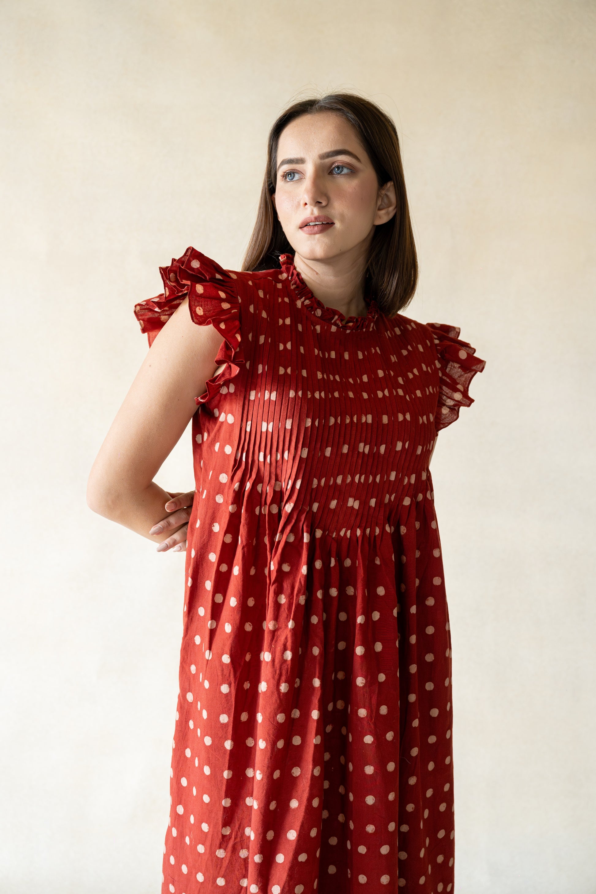 Get ready to turn heads with this funky frock! Featuring playful polka dots, ruffled sleeves, charming pin tucks, a frilly neckline, and handy pockets, this dress is both chic and comfy. Whether you're dressing to impress or just feeling fancy, the Starry Madder Daydream Dress is the perfect choice for any occasion.