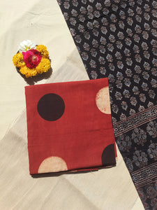 Image of the handcrafted Ajrakh Cosmic Polka Dots Suit Set, featuring cosmic polka dots hand block printed on madder-dyed pure cotton. The set includes a stunning black Ajrakh dupatta with floral and paisley motifs, all naturally dyed and eco-friendly.