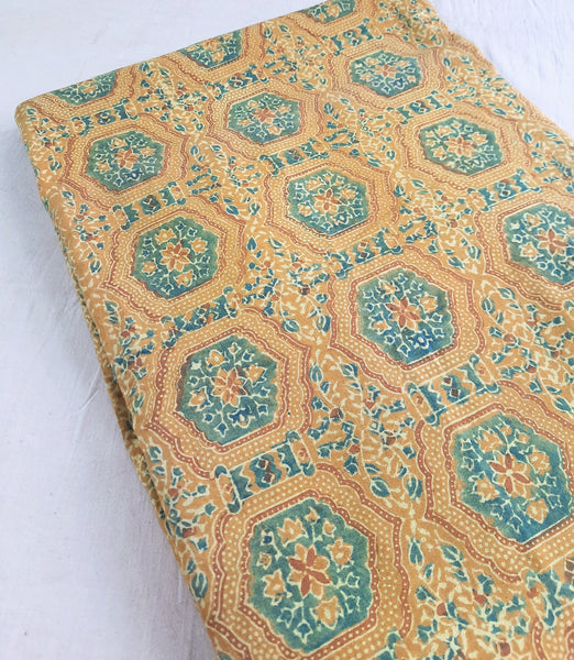 "Image: Turmeric Dyed Pure Cotton Fabric with Ajrakh hand block prints by Turquoisethestore, showcasing vibrant natural hues and intricate designs."