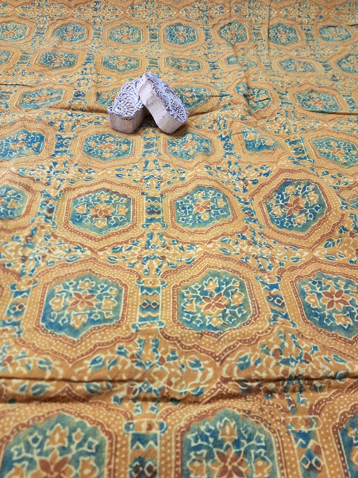"Image: Turmeric Dyed Pure Cotton Fabric with Ajrakh hand block prints by Turquoisethestore, showcasing vibrant natural hues and intricate designs."