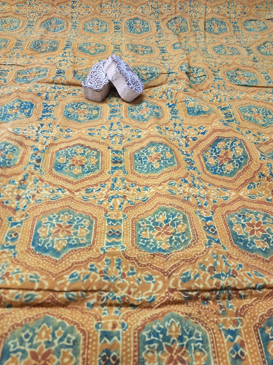 "Image: Turmeric Dyed Pure Cotton Fabric with Ajrakh hand block prints by Turquoisethestore, showcasing vibrant natural hues and intricate designs."
