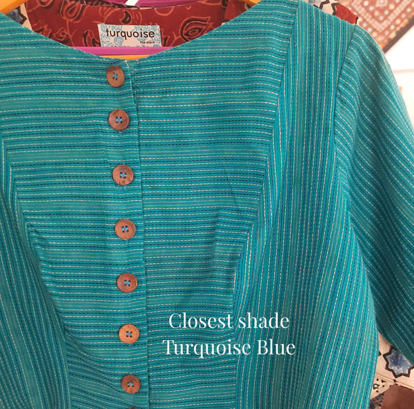 Turquoise blue handmade blouse crafted from pure cotton with self-embroidery, natural dyed polka dots lining, wooden button fastening, and boat neck design.