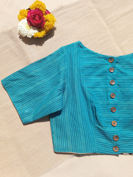 Turquoise blue handmade blouse crafted from pure cotton with self-embroidery, natural dyed polka dots lining, wooden button fastening, and boat neck design.