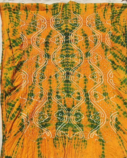 Handcrafted Shibori & Rai Dani Bandhani cotton suit set in yellow and green. Traditional Indian tie-dye dress material, artisan-made in Gujarat. Unstitched three-piece suit set, crafted consciously from pure cotton. Perfect for custom ethnic wear, salwar suits, or fusion outfits. A unique blend of heritage craftsmanship and sustainable fashion, showcasing intricate patterns and vibrant colors.